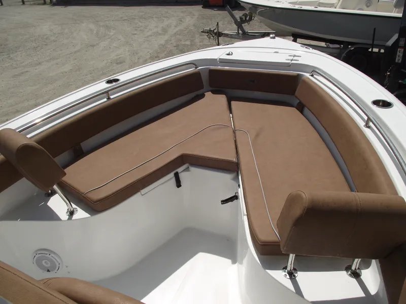 Slide: The Image of 2024 Sea Hunt Ultra 239 SE boat with brown cushioned seating in the bow area. - 7