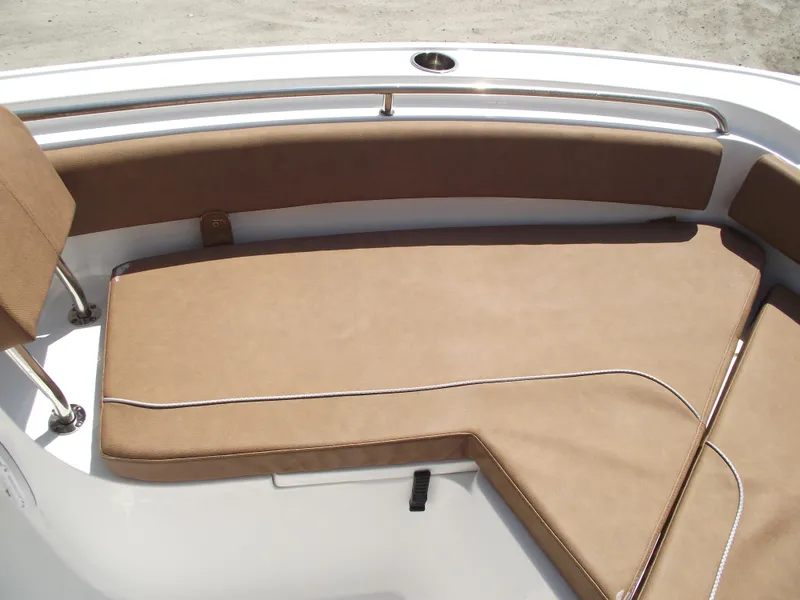 Slide: The Image of 2024 Sea Hunt Ultra 239 SE boat with tan cushioned seating area. - 8