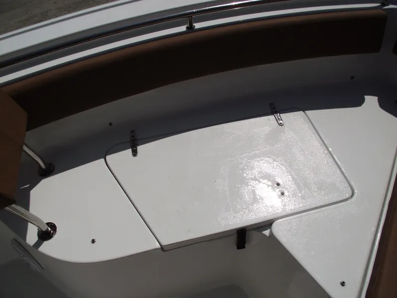 Slide: The Image of 2024 Sea Hunt Ultra 239 SE boat interior, featuring a sleek, white deck with seating. - 9