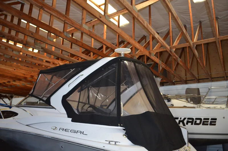The Image of 2008 Regal 3360 Window Express boat stored in a wooden-roofed indoor facility. - 0