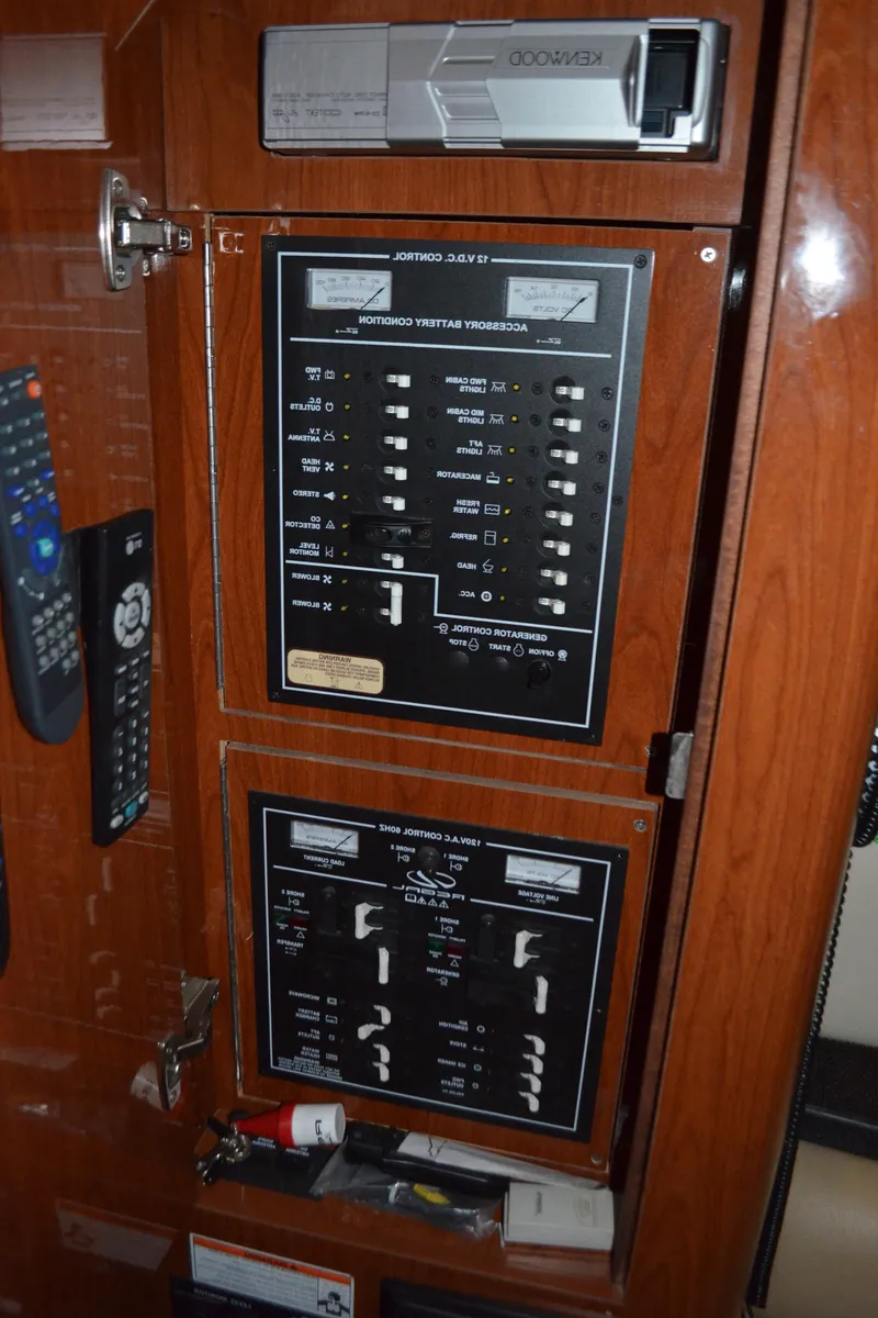 Slide: The Image of Control panel inside 2008 Regal 3360 Window Express boat, featuring switches and remotes. - 21