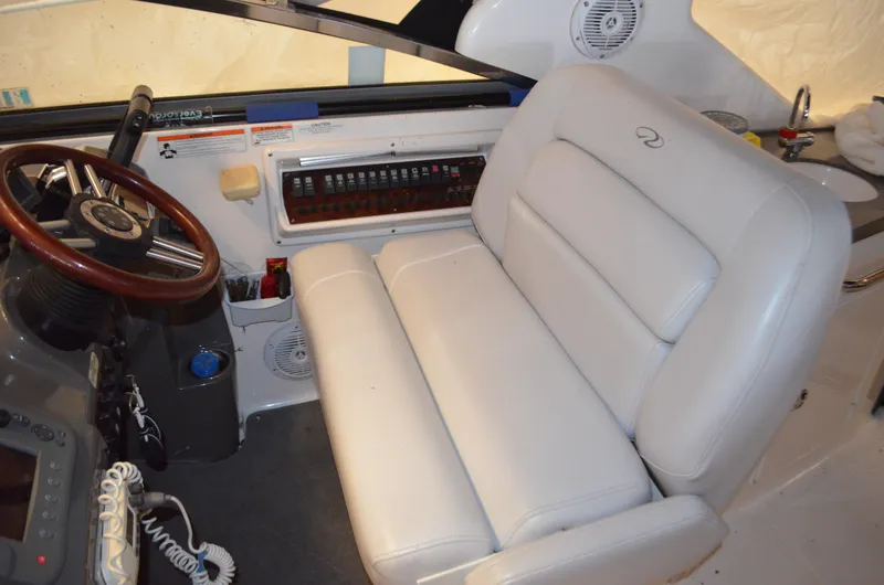 Slide: The Image of 2008 Regal 3360 Window Express helm with white leather seat and control panel. - 3