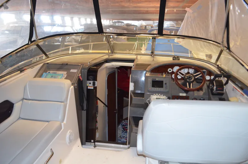 Slide: The Image of 2008 Regal 3360 Window Express boat interior with helm, seating, and cabin entrance. - 5