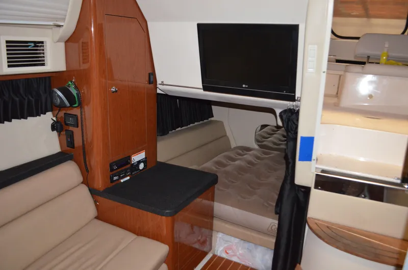Slide: The Image of Interior of 2008 Regal 3360 Window Express boat with seating, TV, and cabin area. - 8