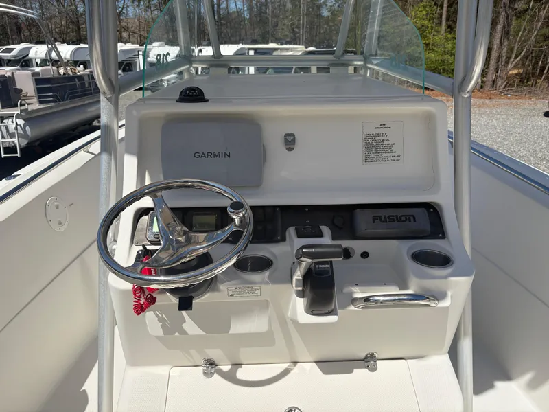 Slide: The Image of 2011 Sailfish 218 boat console with Garmin navigation, Fusion audio, and steering wheel. - 12
