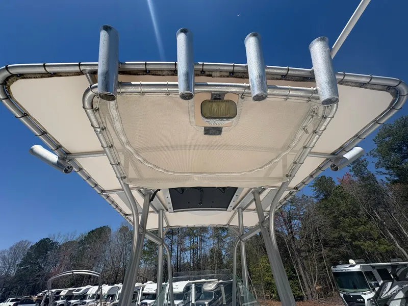 Slide: The Image of T-top view of 2011 Sailfish 218 boat with rod holders against blue sky. - 13