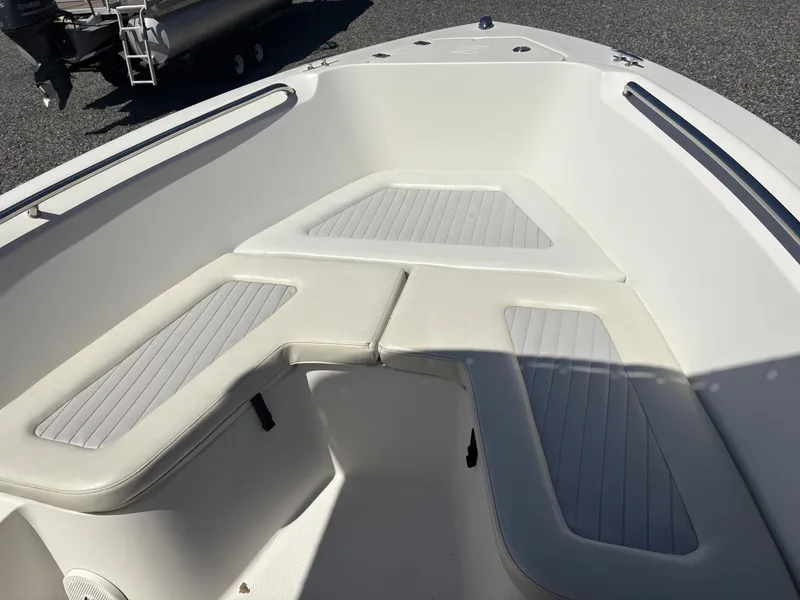 Slide: The Image of Bow seating area of a 2011 Sailfish 218 boat with cushioned benches. - 14