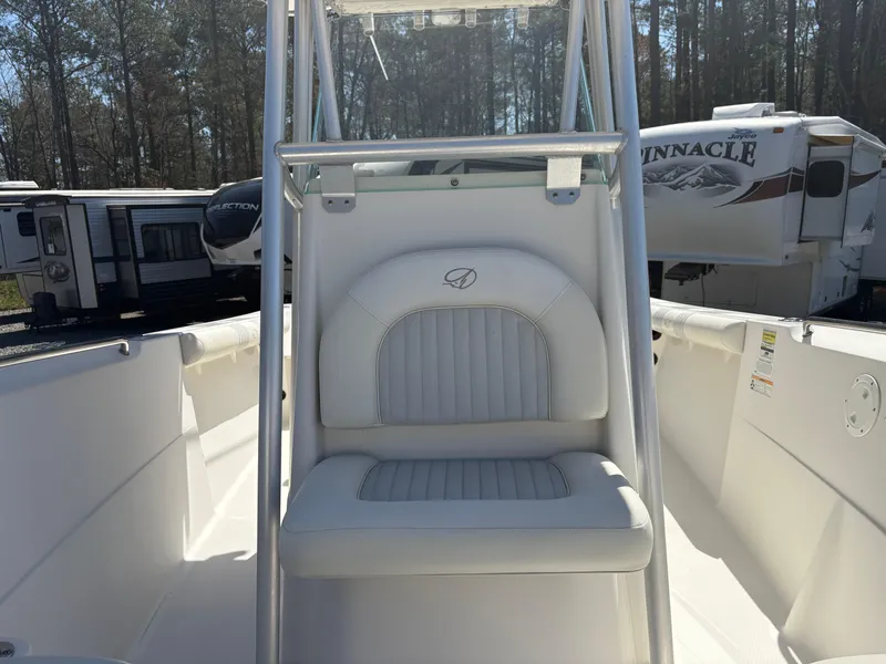 Slide: The Image of 2011 Sailfish 218 boat interior with white seating and console, surrounded by RVs and trees. - 15