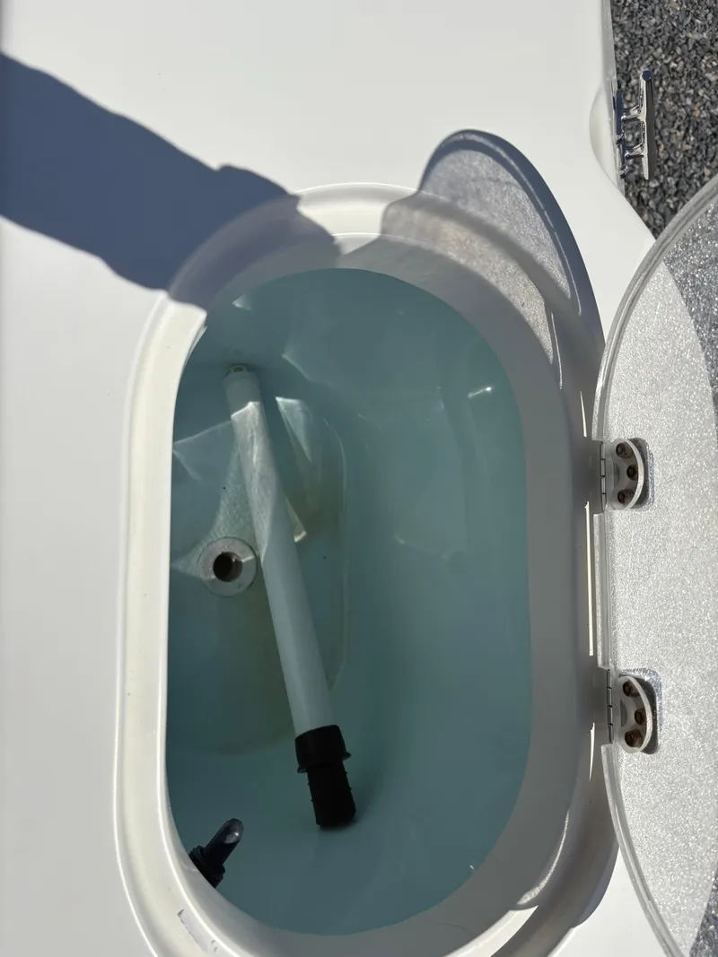 Slide: The Image of Open livewell on 2011 Sailfish 218 boat, showing interior and water. - 16