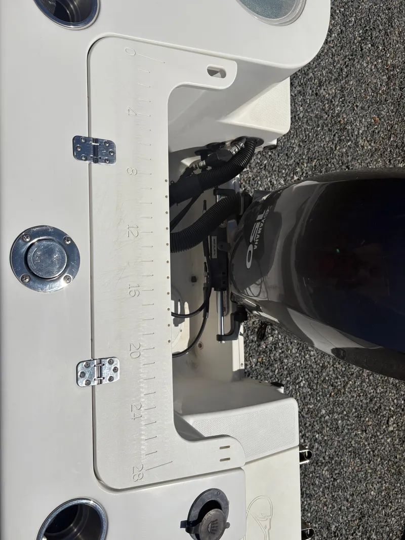 Slide: The Image of 2011 Sailfish 218 boat with motor, featuring a measuring board and deck details. - 17