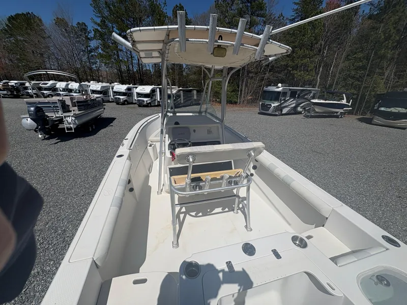 Slide: The Image of 2011 Sailfish 218 boat with center console, parked in a lot with RVs and trees. - 9
