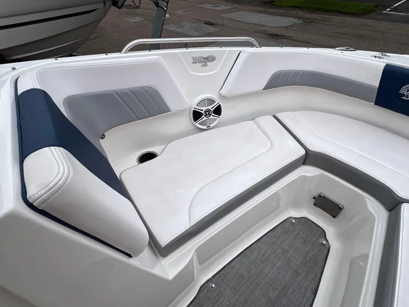 Slide: The Image of 2019 Chaparral 23 H2O Surf boat interior with white and blue seating. - 15