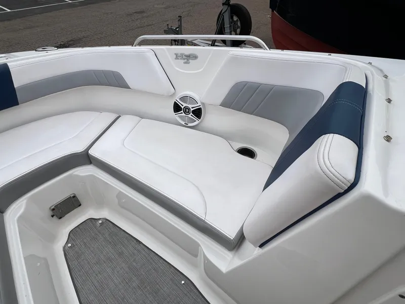 Slide: The Image of 2019 Chaparral 23 H2O Surf boat interior with white and blue seating. - 16