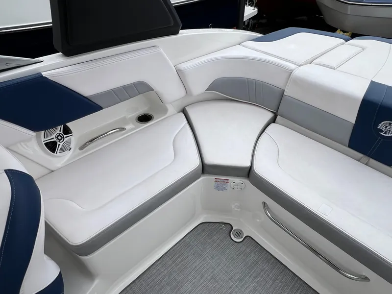 Slide: The Image of 2019 Chaparral 23 H2O Surf boat interior with white and blue seating. - 6