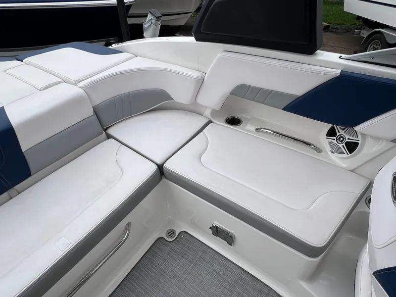Slide: The Image of 2019 Chaparral 23 H2O Surf boat interior with white and blue seating. - 7