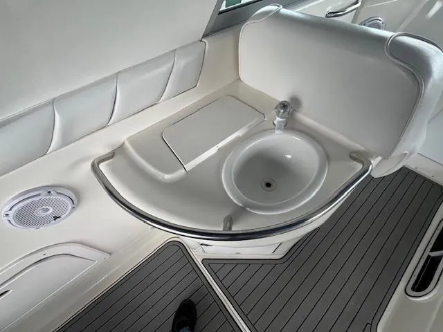 Slide: The Image of 1996 Sea Ray 330 Sundancer interior with sink and seating area. - 11