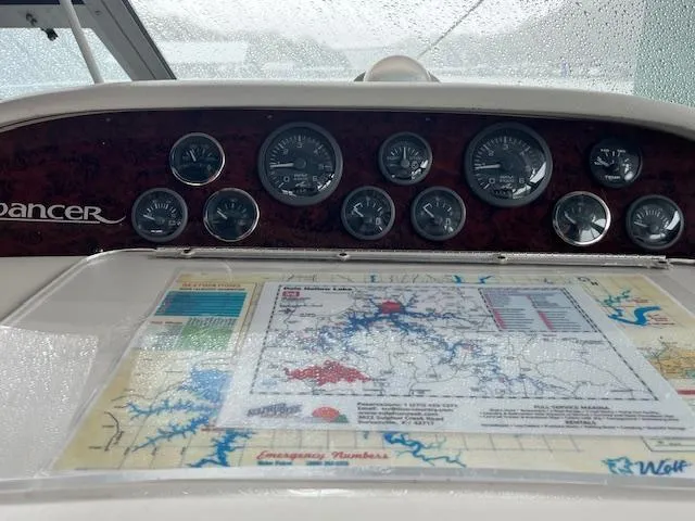 Slide: The Image of Dashboard of a 1996 Sea Ray 330 Sundancer with navigation map and gauges. - 12