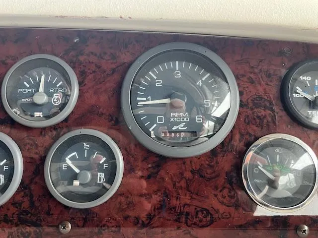 Slide: The Image of Dashboard of a 1996 Sea Ray 330 Sundancer boat with various gauges. - 13