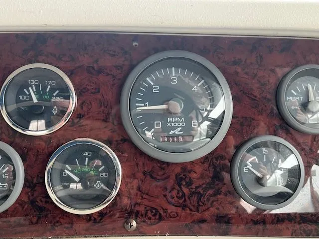Slide: The Image of Dashboard gauges of a 1996 Sea Ray 330 Sundancer boat. - 14