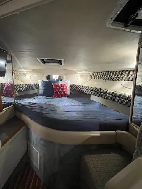 Slide: The Image of Interior cabin of 1996 Sea Ray 330 Sundancer with cozy bed and decorative pillows. - 22
