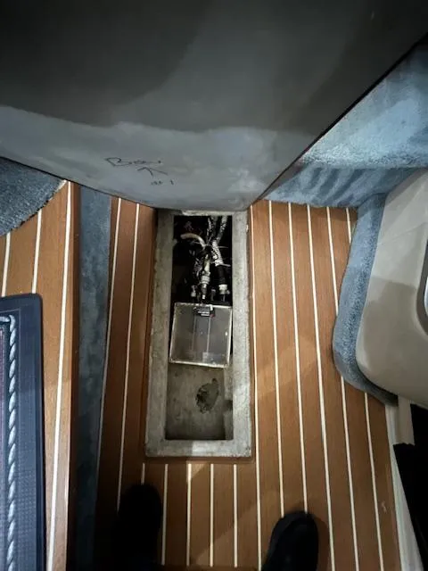 Slide: The Image of 1996 Sea Ray 330 Sundancer interior with wooden flooring and open hatch. - 26