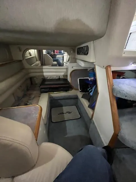 Slide: The Image of Interior of a 1996 Sea Ray 330 Sundancer boat, featuring seating and storage areas. - 27