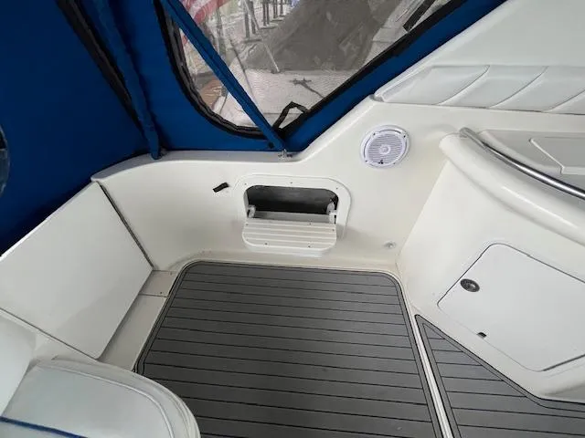 Slide: The Image of Interior view of a 1996 Sea Ray 330 Sundancer boat, featuring seating and speaker. - 42