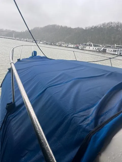 Slide: The Image of 1996 Sea Ray 330 Sundancer covered with blue tarp at marina on cloudy day. - 7