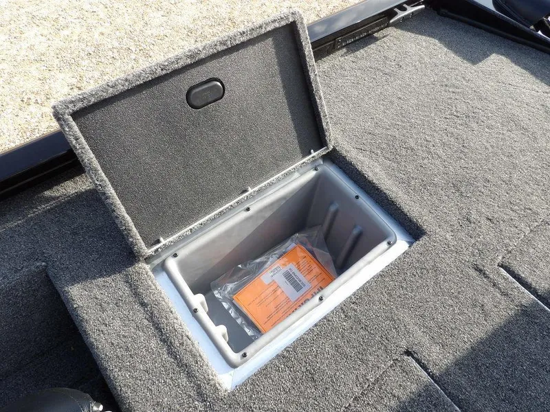 Slide: The Image of Open storage compartment in 2025 Crestliner XFC 189 boat, featuring carpeted interior. - 14