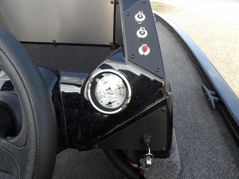 Slide: The Image of Dashboard of 2025 Crestliner XFC 189 boat with RPM gauge and control buttons. - 16