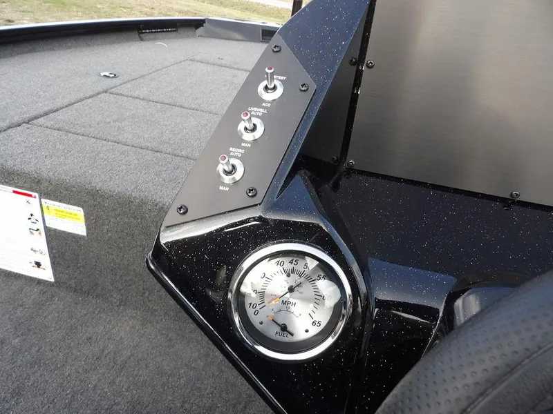Slide: The Image of 2025 Crestliner XFC 189 boat dashboard with speedometer and control switches. - 18
