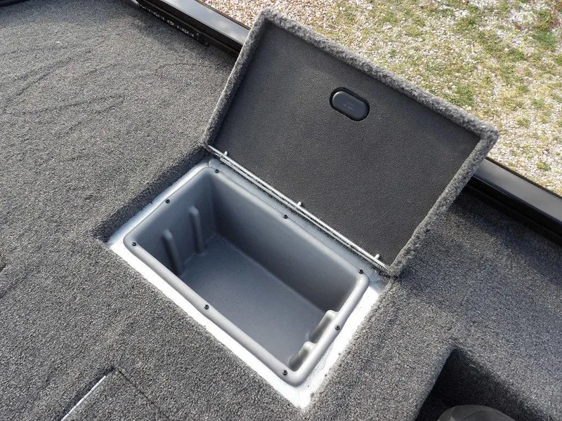 Slide: The Image of Open storage compartment on 2025 Crestliner XFC 189 boat, featuring carpeted interior. - 19