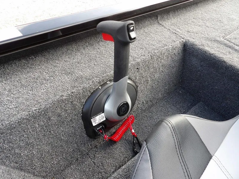 Slide: The Image of Throttle control lever in 2025 Crestliner XFC 189 boat, featuring gray carpeted interior. - 20