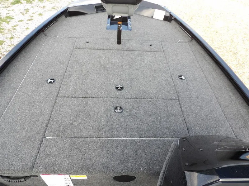 Slide: The Image of 2025 Crestliner XFC 189 boat deck with gray carpet and storage compartments. - 21