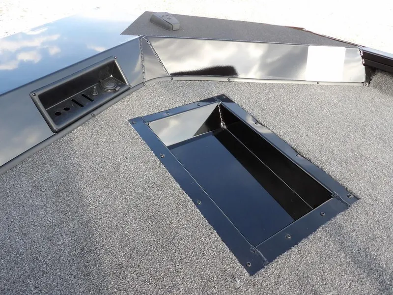 Slide: The Image of 2025 Crestliner XFC 189 boat deck with storage compartment and control panel. - 25