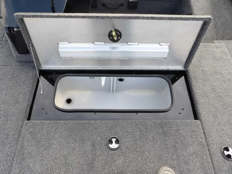 Slide: The Image of Open storage compartment in 2025 Crestliner XFC 189 boat, featuring carpeted interior. - 27