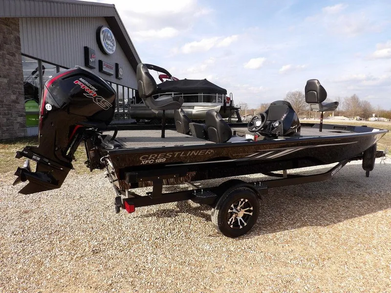 Slide: The Image of 2025 Crestliner XFC 189 fishing boat with powerful outboard motor, parked outdoors. - 3