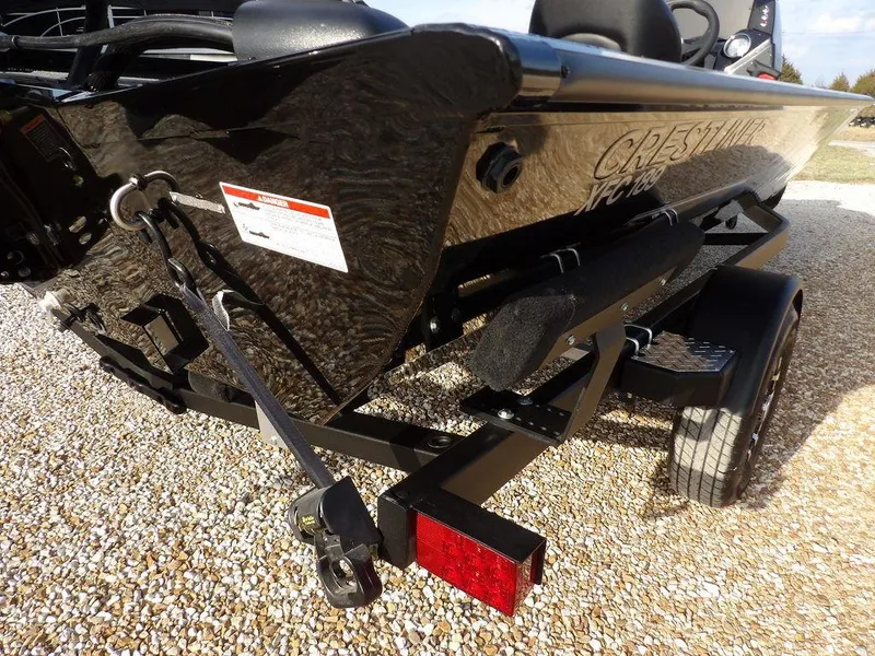Slide: The Image of 2025 Crestliner XFC 189 boat on trailer, rear view, parked on gravel. - 33