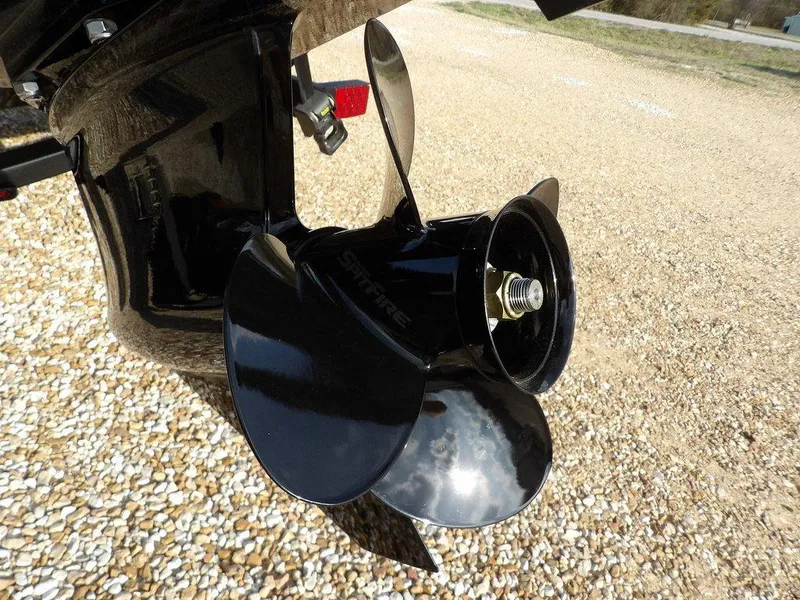 Slide: The Image of Close-up of a 2025 Crestliner XFC 189 boat propeller on gravel surface. - 38