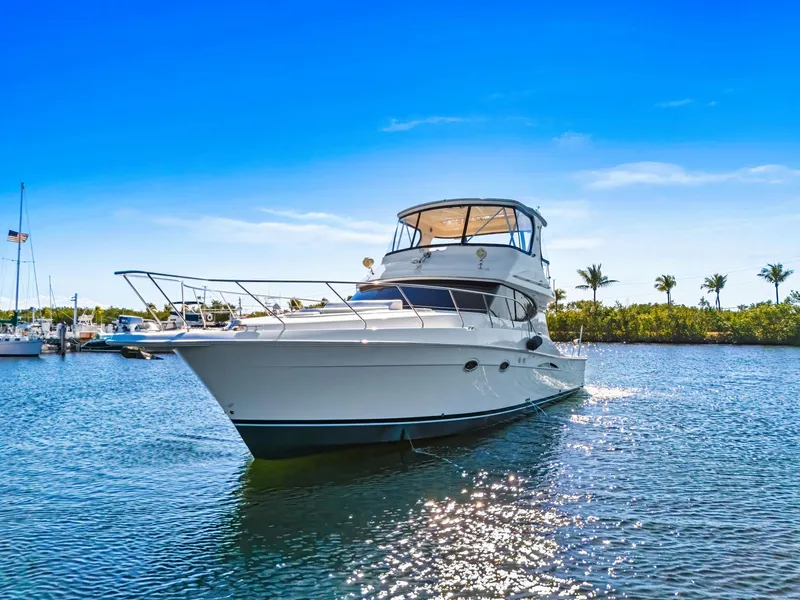 Slide: The Image of 2007 Silverton 45 Convertible yacht on serene water under clear blue sky. - 1