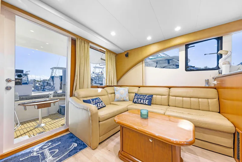 Slide: The Image of Luxurious interior of 2007 Silverton 45 Convertible yacht with beige leather seating. - 12