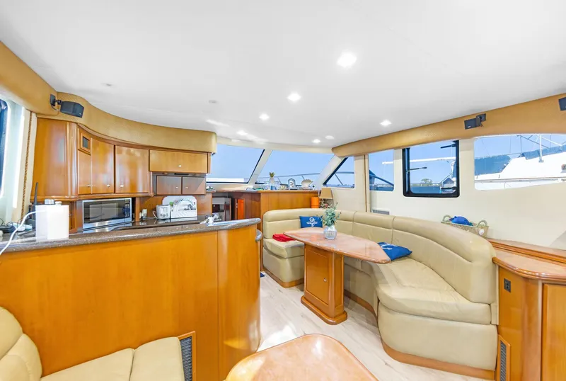 Slide: The Image of Luxurious interior of a 2007 Silverton 45 Convertible yacht with elegant wood finishes. - 13