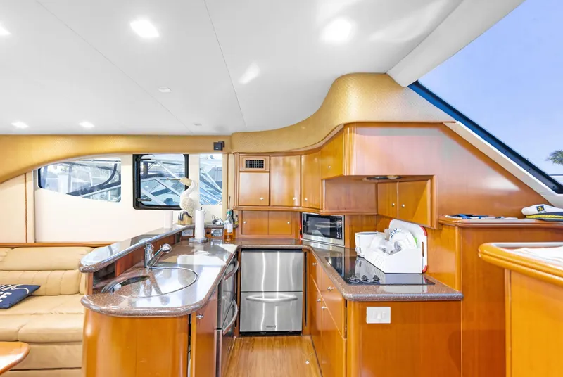 Slide: The Image of Luxurious interior of a 2007 Silverton 45 Convertible yacht with modern kitchen amenities. - 15
