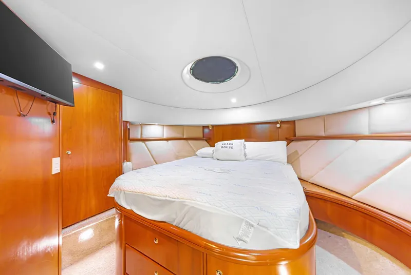 Slide: The Image of Luxurious bedroom interior of 2007 Silverton 45 Convertible yacht with elegant wood finishes. - 22