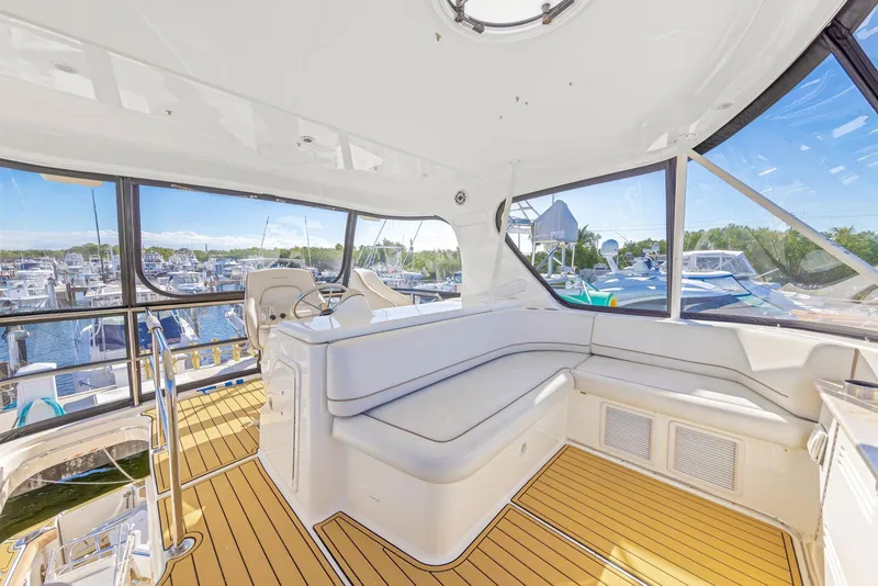 Slide: The Image of Luxurious interior of 2007 Silverton 45 Convertible yacht with marina view. - 25