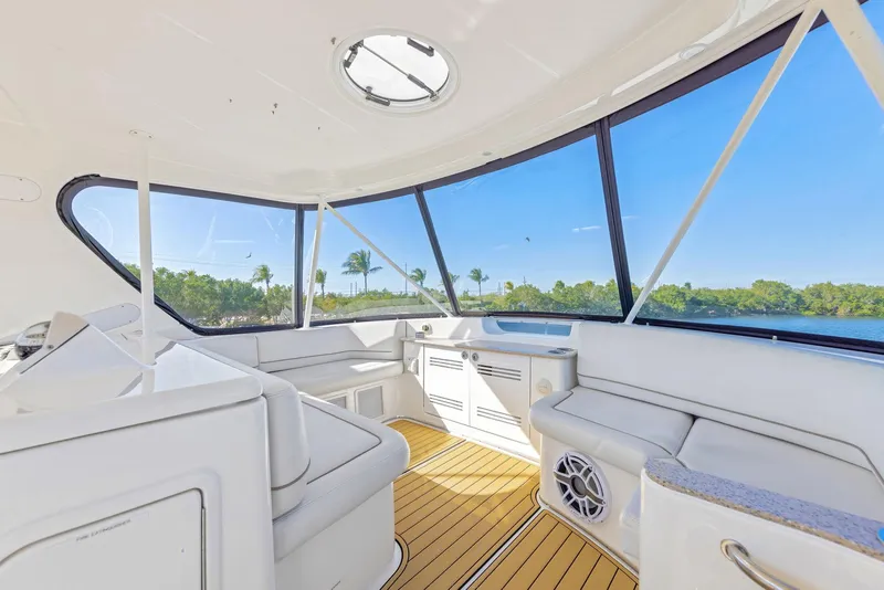 Slide: The Image of Interior of 2007 Silverton 45 Convertible yacht with panoramic windows and sleek seating. - 26
