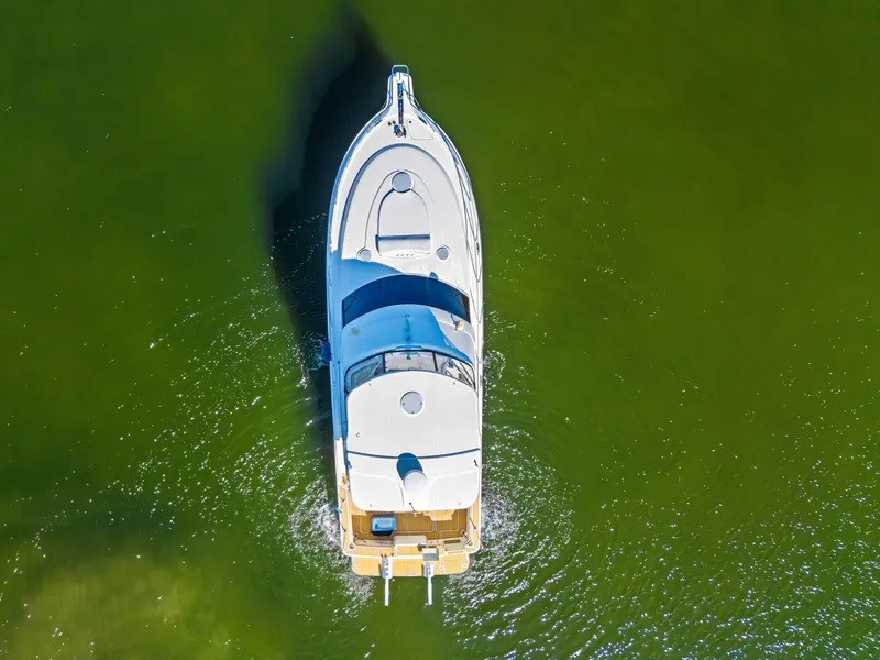 Slide: The Image of Aerial view of 2007 Silverton 45 Convertible yacht on green water. - 8