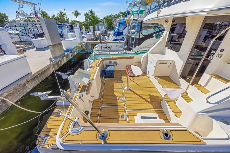 Slide: The Image of 2007 Silverton 45 Convertible yacht docked, featuring spacious deck and modern amenities. - 9