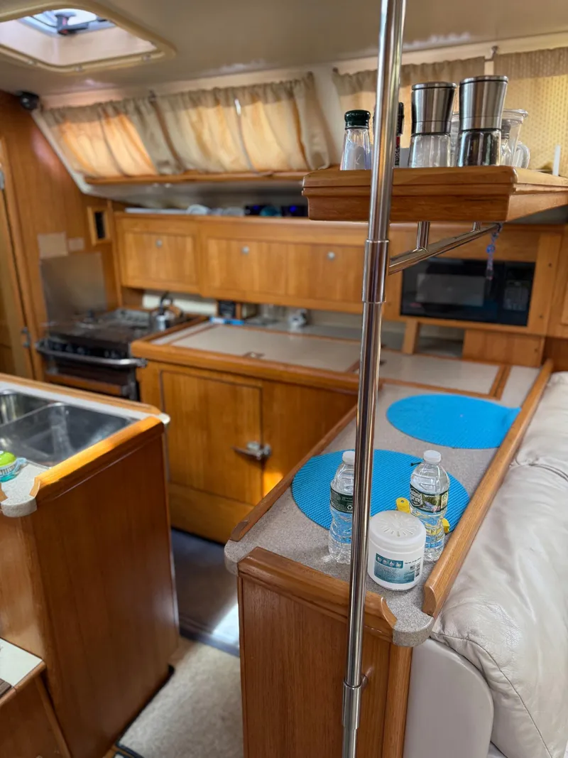 Slide: The Image of Interior of 2001 Hunter 460 yacht kitchen with wooden cabinets and modern amenities. - 14