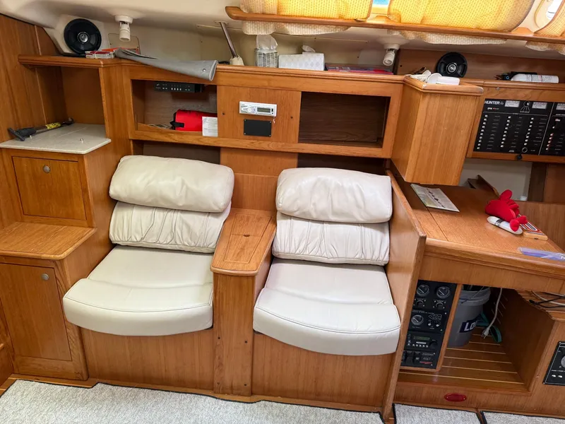 Slide: The Image of Interior of a 2001 Hunter 460 yacht with wooden cabinetry and cushioned seating. - 18